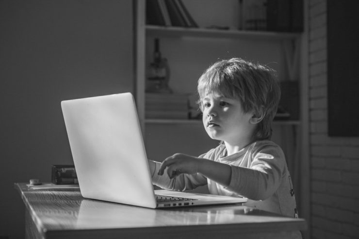 Child coding on a laptop