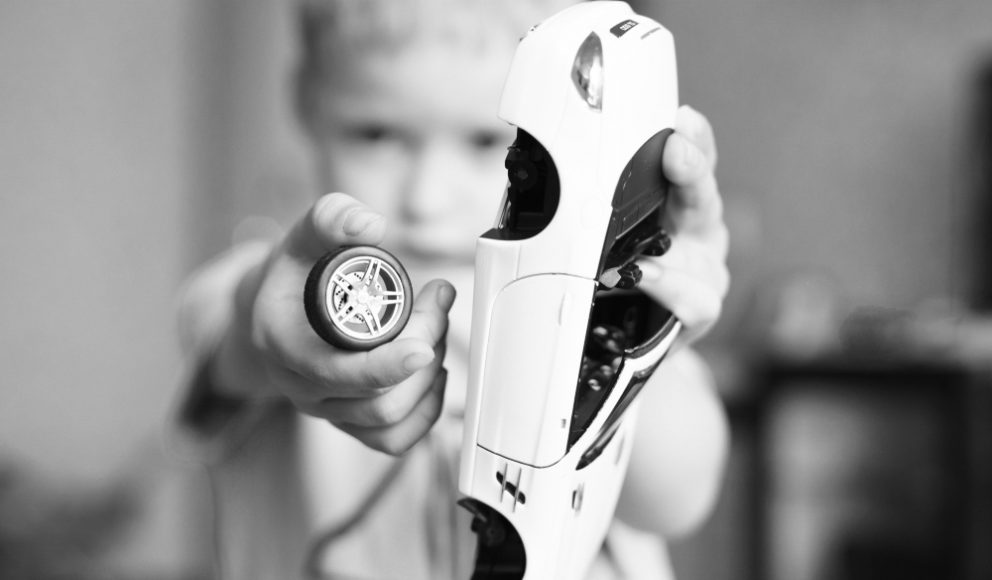 EVP blog image. image shows a little child holding a broken car toy.