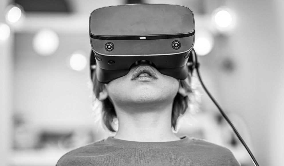 Hiring in the Metaverse - is this the future? blog image cover. Image is of a boy wearing a VR headset