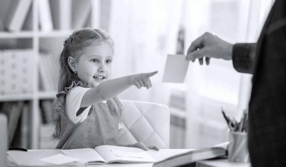 Girl choosing an answer on a post it note. Girl is sat at a desk being home-schooled. Image is for the non-technical roles blog post