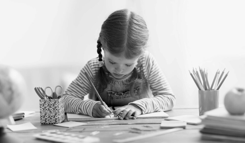 Black and white image of a girl drawing and painting. Cover image for the the Skills needed to be a UI_UX designer blog.