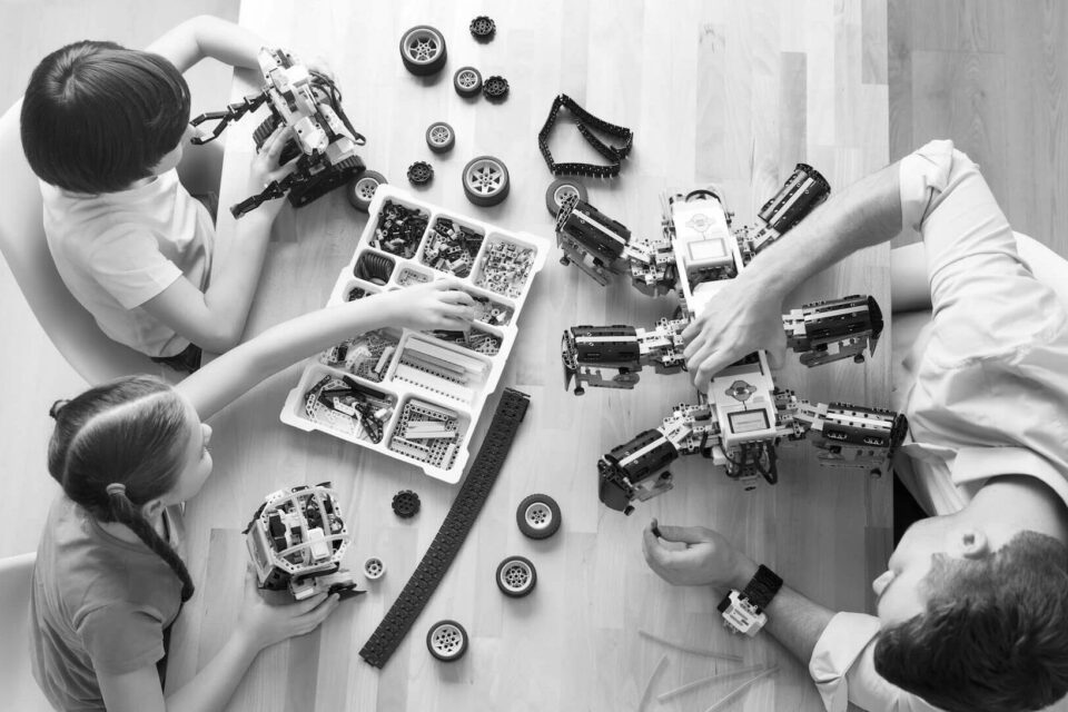 Black and white image of kids building a robot. Cover image for the AI Job Search blog.