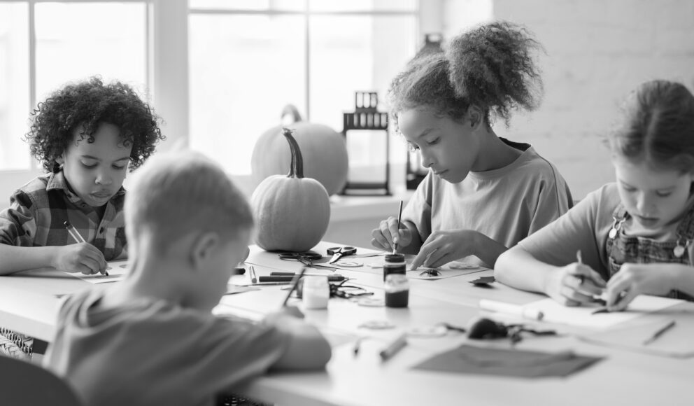 Black and white image of kids painting. Cover image for the Employer Branding blog.